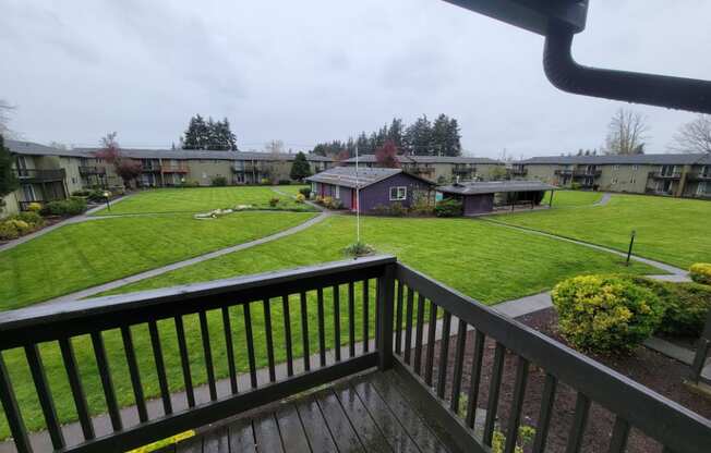 the view from our deck looking out at our yard and apartment buildings