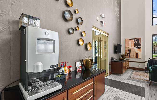 A modern kitchen with a coffee machine and a vase on the counter.