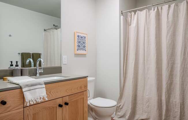 a bathroom with a shower and a sink and a toilet at Slabtown Square Apartments, Portland