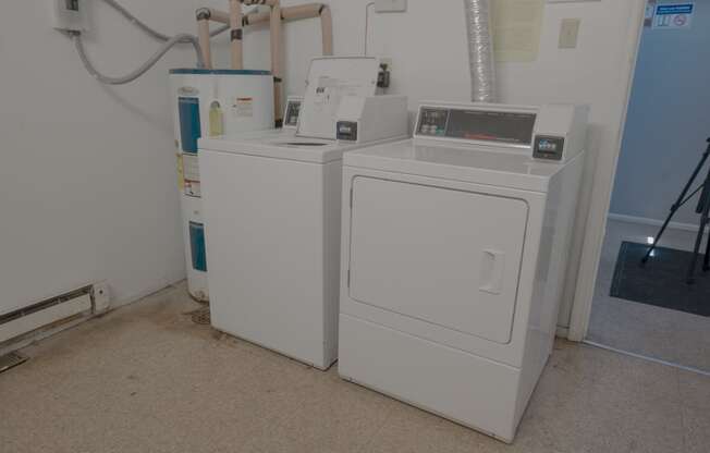 two washing machines next to each other in a room