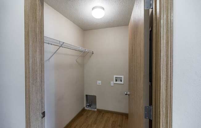 Empty room with a closet and a door to a bathroom at Sunset Ridge Apartments in Bismarck