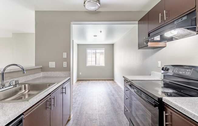 a kitchen with stainless steel appliances and white quartz countertops