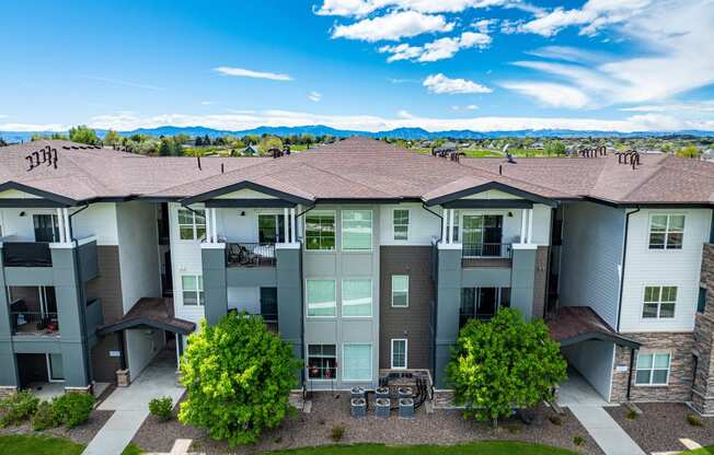 an aerial view of an apartment building with grass and trees at Arbour Commons, Colorado, 80023