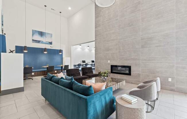 A living room with a blue couch and a fireplace.