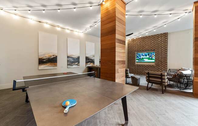 a game room with a ping pong table and a television