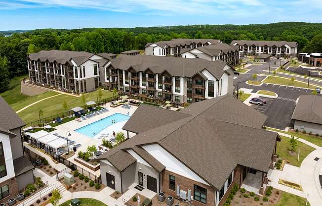 an aerial view of an apartment complex with a swimming pool