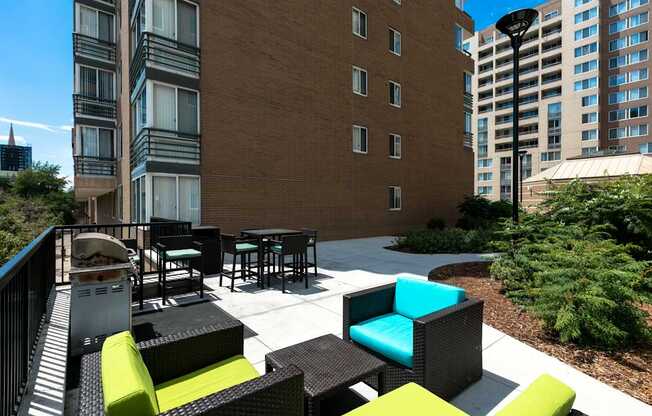 a patio with chairs and tables in front of a building