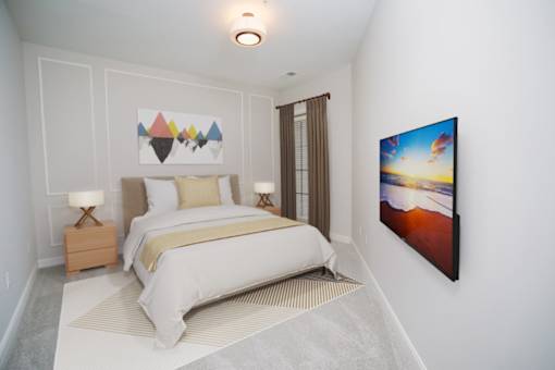 a bedroom with a bed and a painting on the wall at Fairfax, Ohio