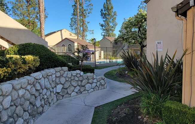 Beautifully landscaped walkway to one of the pools at Northwood Apartments in Upland, California.