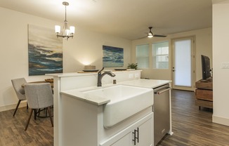 a kitchen with a large sink and a table with chairs