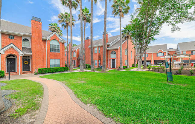 A brick building with a green lawn in front.