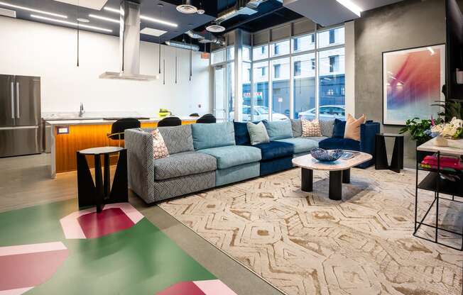 a living room filled with furniture and a large window