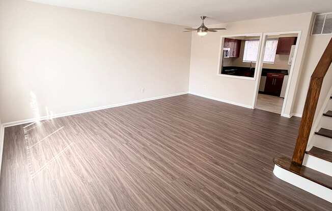 A room with wooden flooring and a ceiling fan.