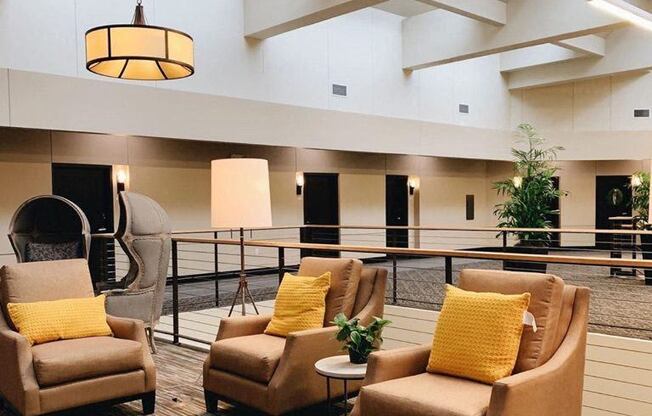 a lobby with couches and chairs and a fire place