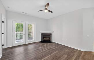 Renovated apartment living room with fireplace and balcony