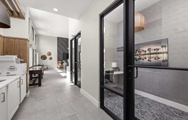 a hallway with a kitchen and a dining room with glass doors at The Sophia, Venice, FL, 34275