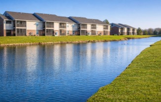A row of houses are next to a body of water.