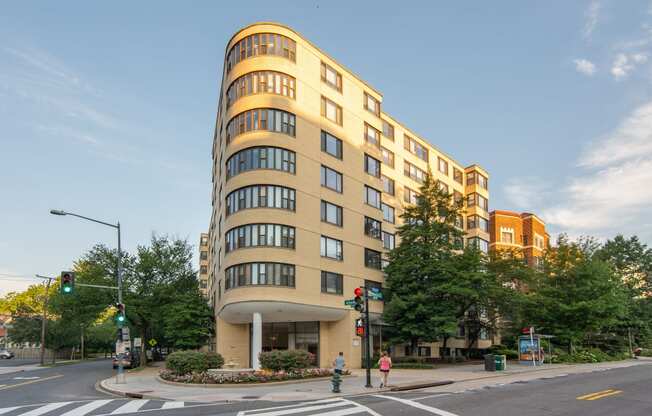 a tall building on the corner of a city street