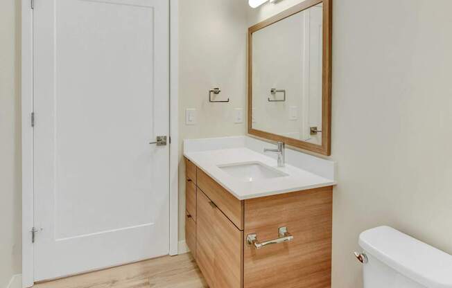 A white toilet sits next to a sink in a bathroom.