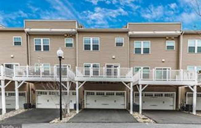 Three level townhouse with wood floor on main level, 2 car garage in the back