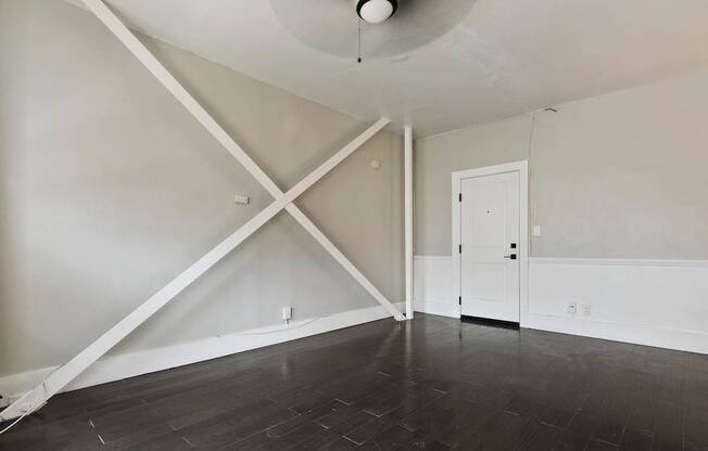 A studio apartment in Pasadena with a white door and a white ceiling fan.