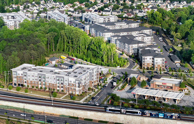 an aerial view of a city with buildings and a train