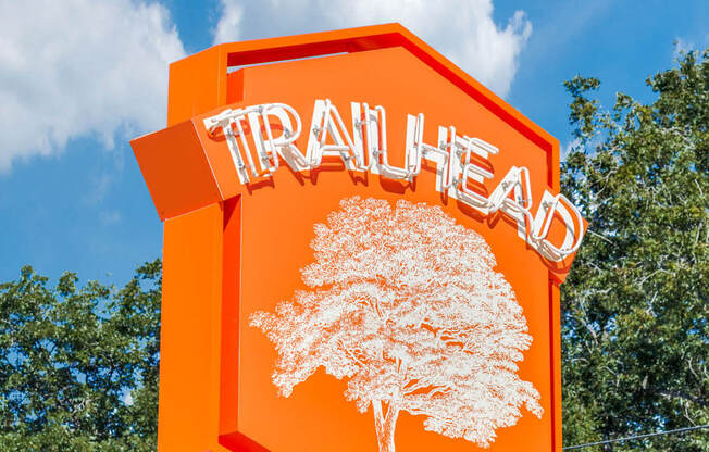 a orange traffic sign with a tree on it