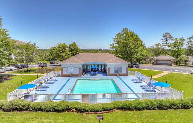 A pool with a building behind it.