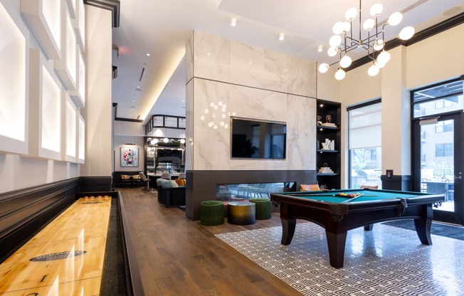 a game room with a pool table and a television