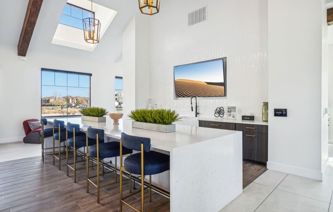 a kitchen with a marble counter top and blue bar stools