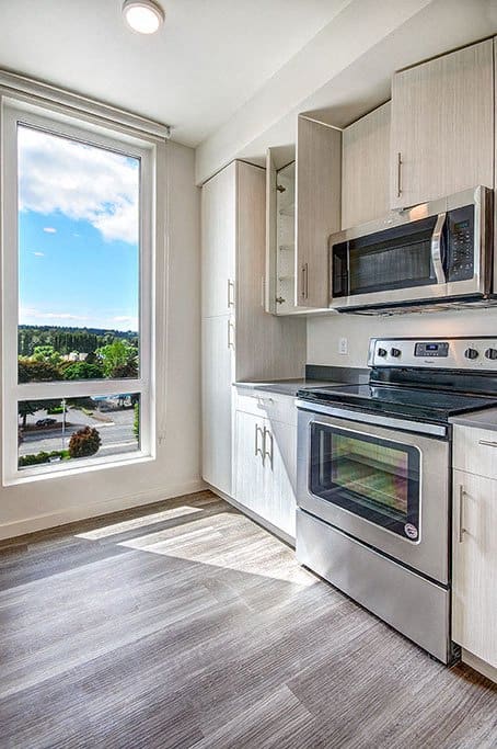 A modern kitchen with a stainless steel oven and microwave. at Ravello Apartments, Redmond