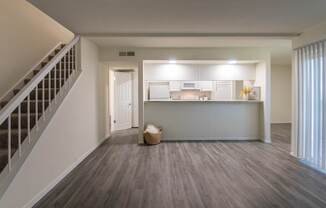 View of the kitchen from the living room in a 2 bedroom, 1.5 bath 1084 sq ft, 2-floor townhome at The Biltmore Apartments located in the Vickery Midtown neighborhood of Dallas, TX.