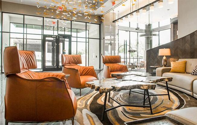 a living room with a couch and chairs and a table