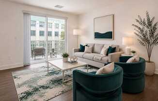 A living room with a white couch, a rug, and a potted plant.