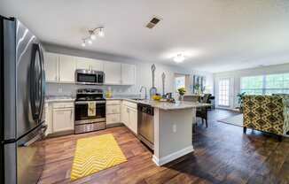 Open Floor Plan showing Kitchen with Bar, Dining Area, and Living Room