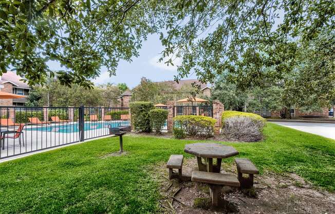 a backyard with a pool and picnic table