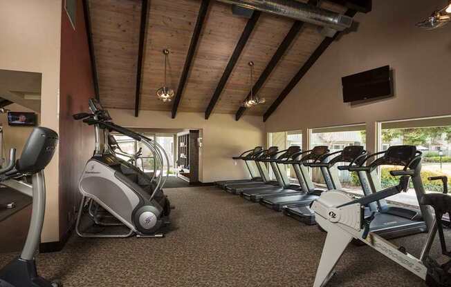 A gym with treadmills and exercise bikes.