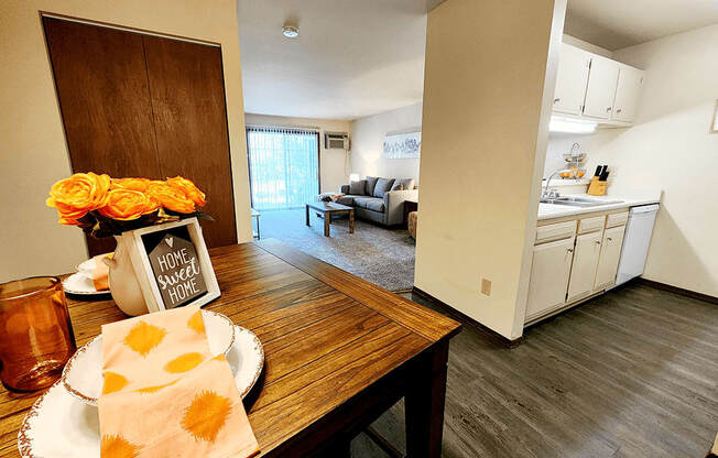 a dining room and living room with a table and a kitchen