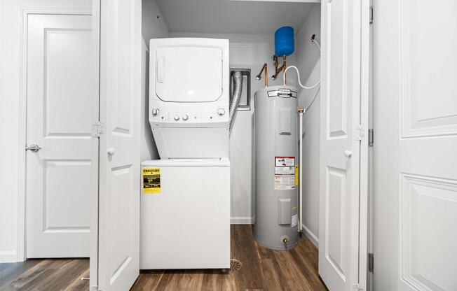 a small laundry room with a washer and dryer  at Union at Wiley, Cedar Rapids, 52404