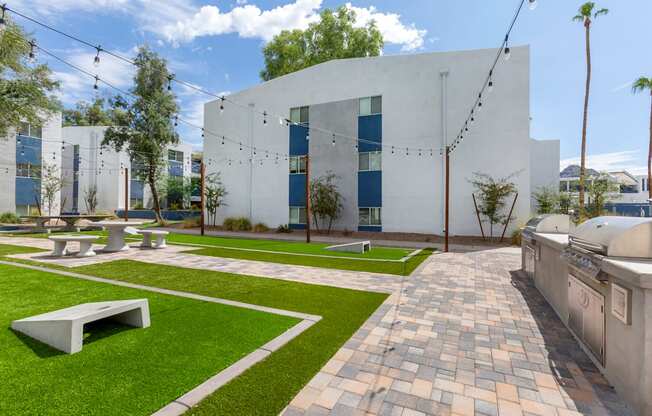 A white building with a green lawn in front.