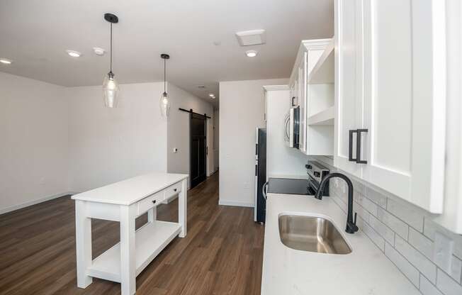 a kitchen with white cabinets and a sink and a counter top at The Crossings at Windsong, Prescott Valley, 86314