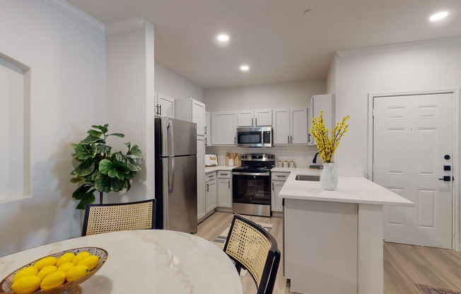 a kitchen with white cabinetry and stainless steel appliances
