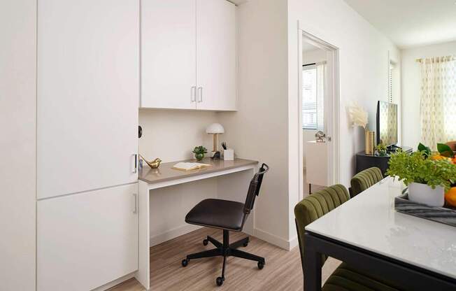 a kitchen or kitchenette with a desk and a chair