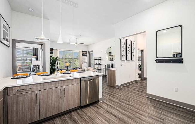 A modern kitchen with wooden floors and a large island.