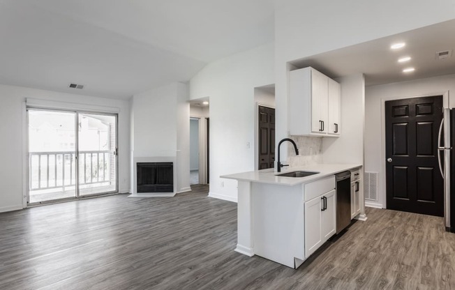 Open Concept Living Space with a Fireplace at Sundance Apartments