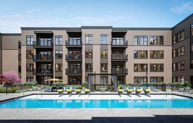 a swimming pool is in front of an apartment building at Link Apartments® Broad Ave, Memphis, TN