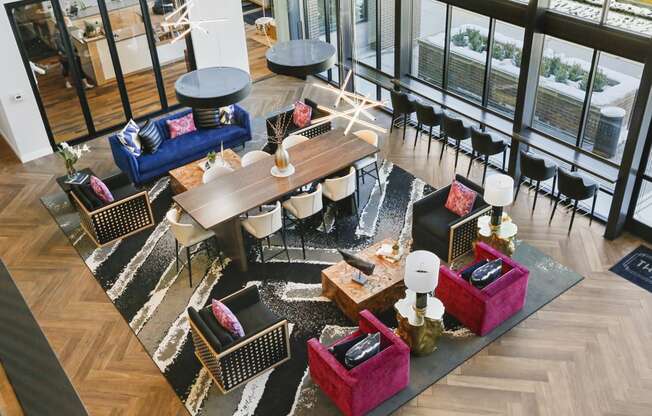 an aerial view of the lobby of a hotel with couches and tables