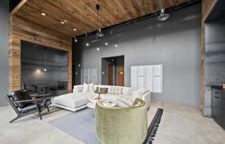 a living room with grey walls and a white couch and a table