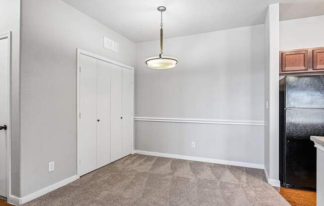 A room with a carpeted floor and a ceiling light.