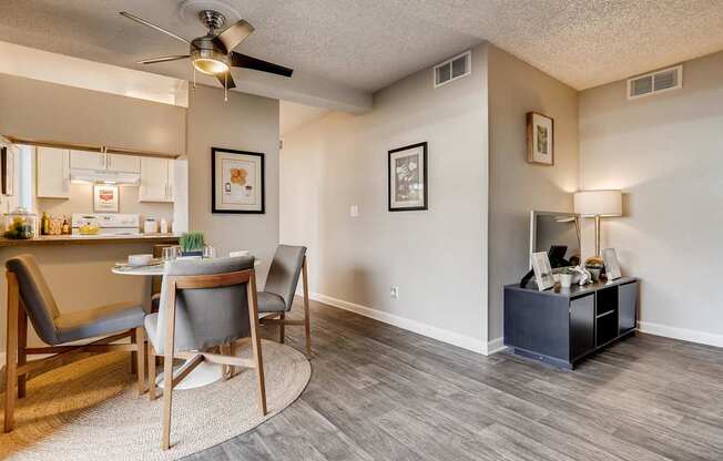 A living room with a grey chair and a wooden table.
